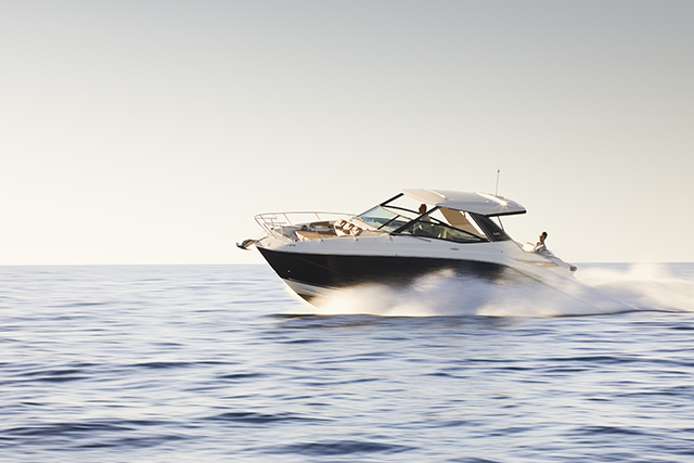 Sea Ray Sundancer 320 cruising at speed across calm open Mediterranean water