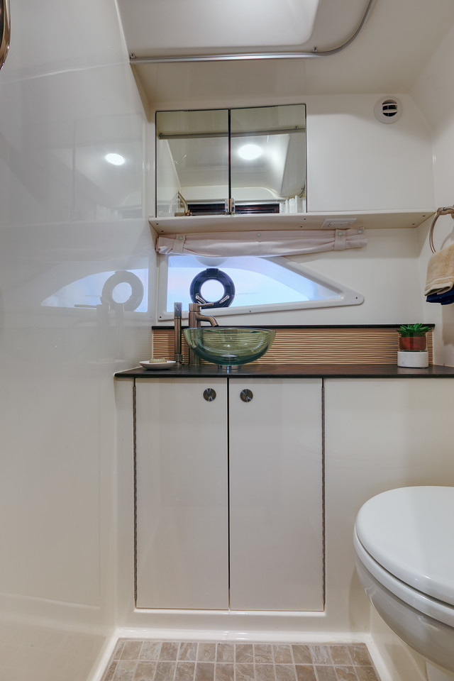 Interior head with vanity and glass basin on board the Sea Ray Sundancer 320