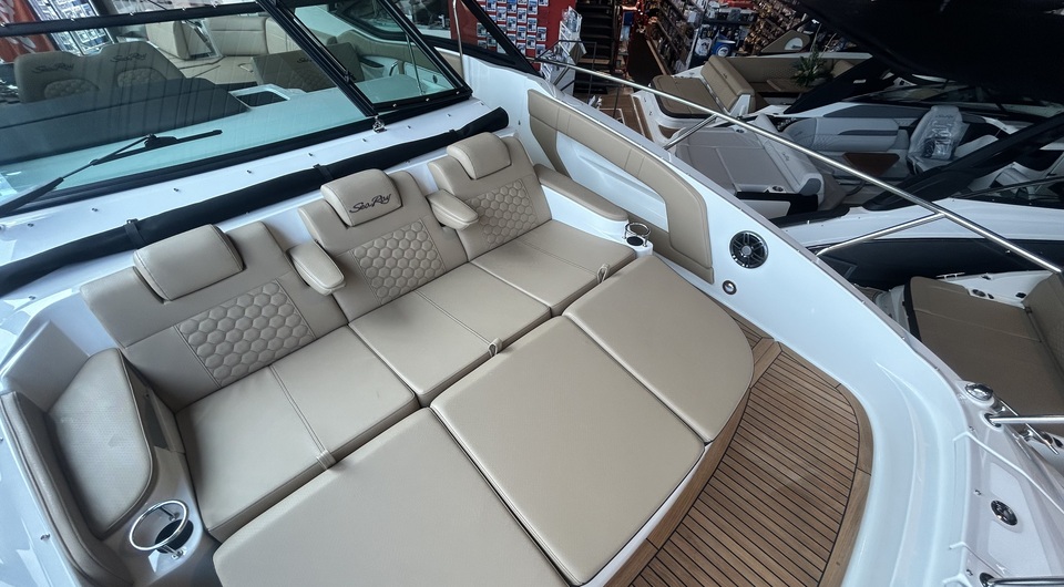 Sun-drenched bow sunbed of the yacht with crisp white cushions